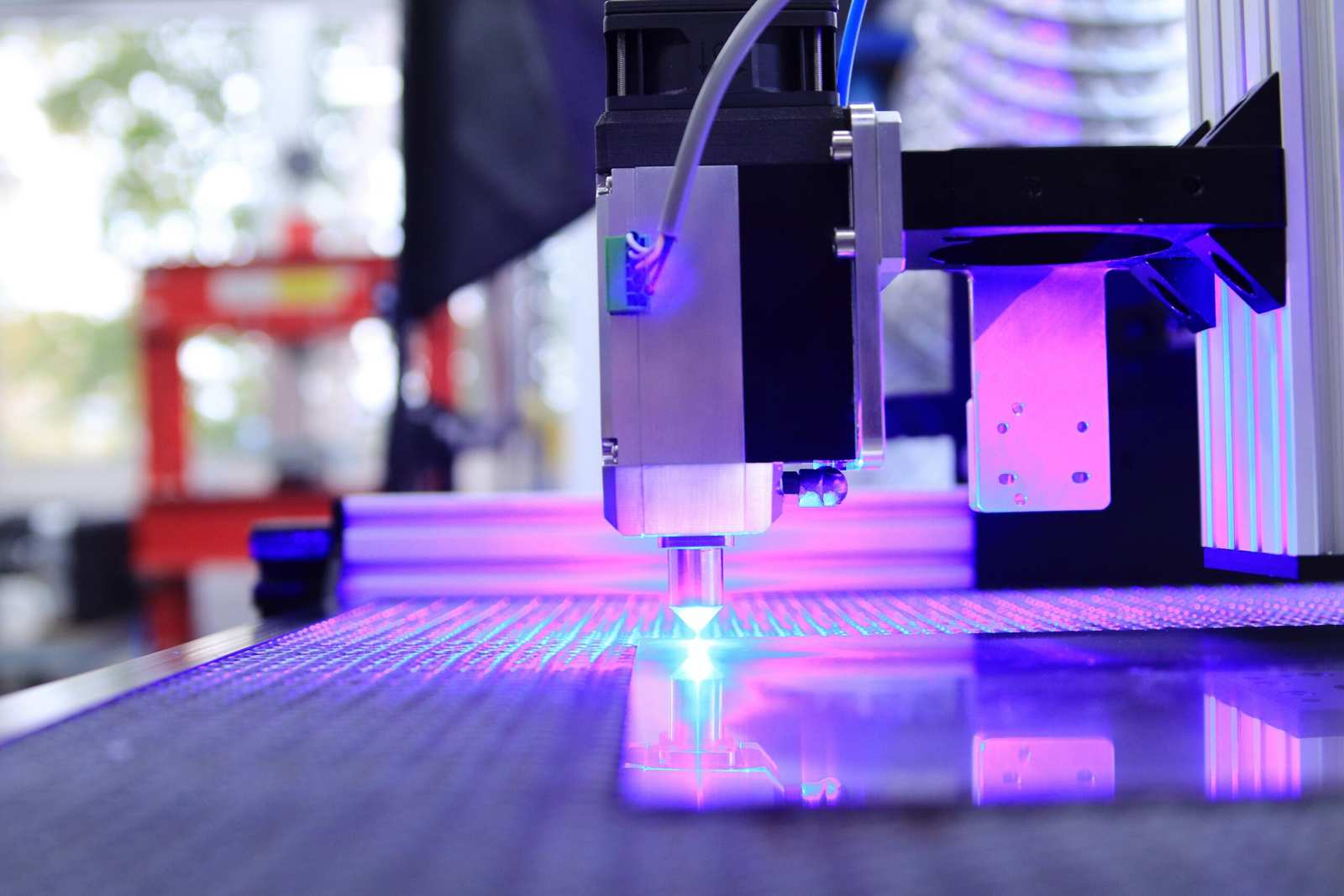 Close-up of a laser cutting machine head and optics